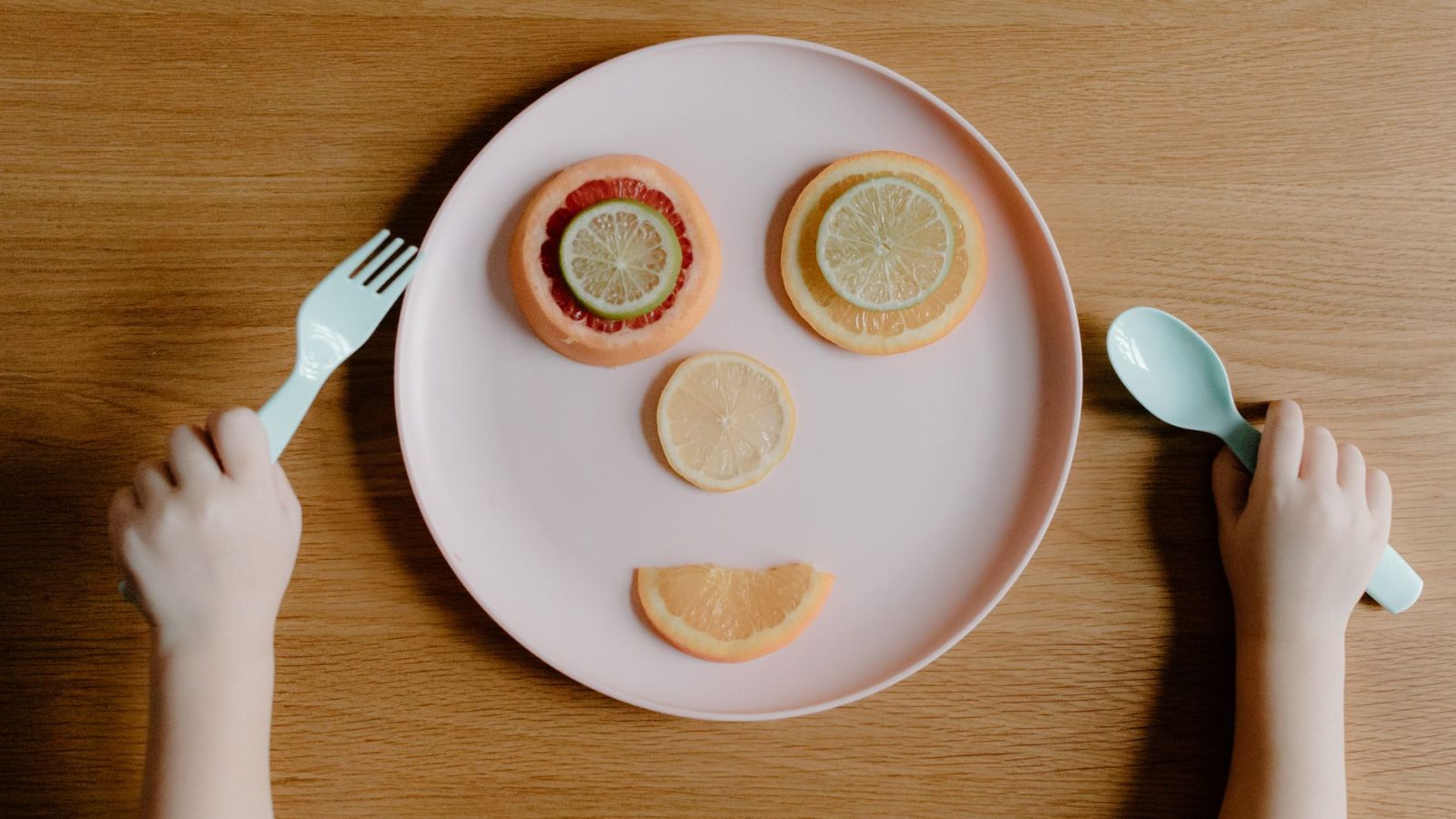 Assiette de fruits frais variés (pomme, raisin, abricot) pour enfant