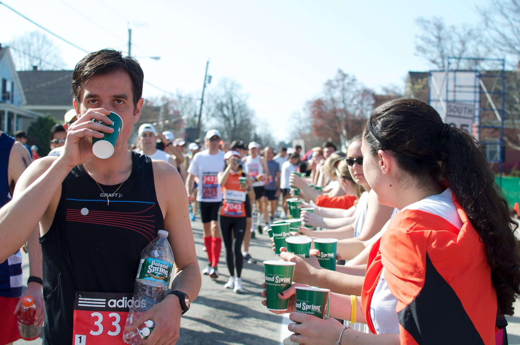 coureurs de marathon qui s'hydratent à un ravitaillement en eau pendant une course